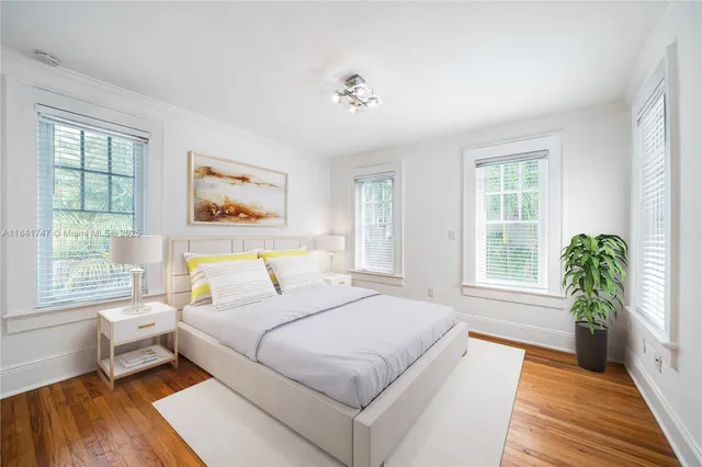 a spacious bedroom with a bed and a large window