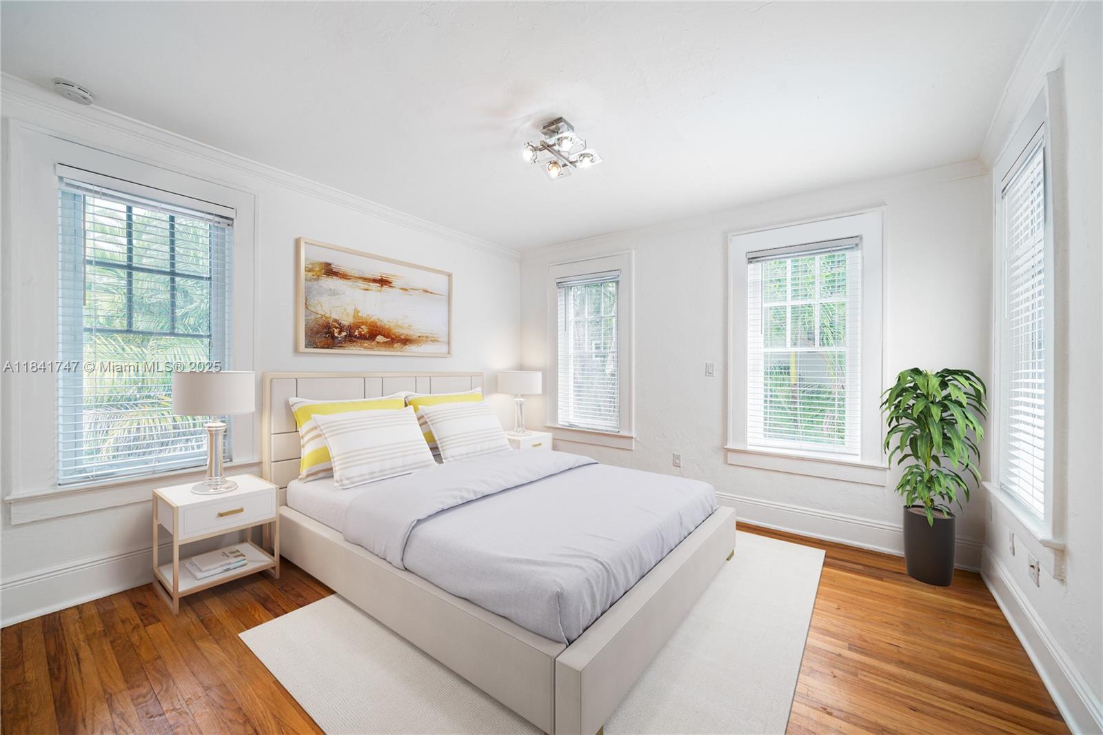 671 Northeast 57th Street Miami, FL 33137 - Photo 27 of 48 a spacious bedroom with a bed and a large window