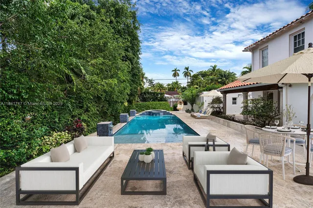 swimming pool view with a seating space