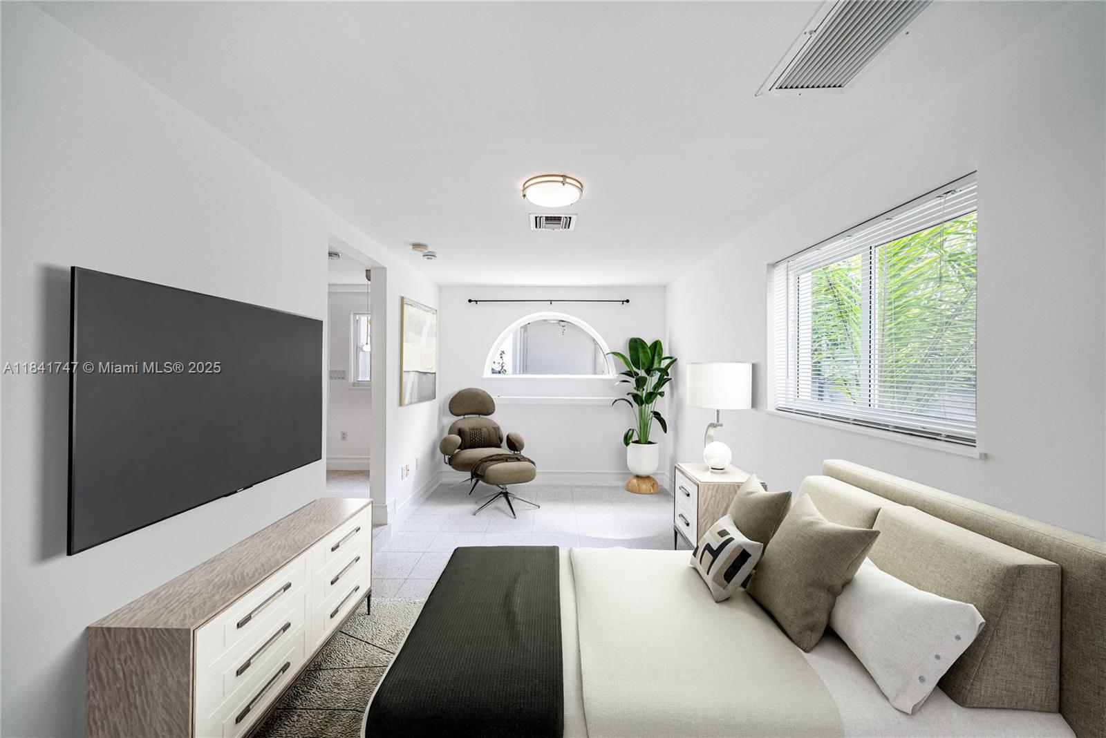 671 Northeast 57th Street Miami, FL 33137 - Photo 39 of 48 a living room with furniture and a flat screen tv