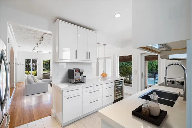 a kitchen with sink refrigerator and cabinets