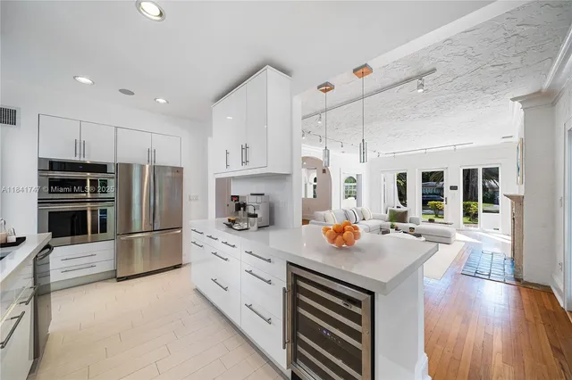 a kitchen with a sink appliances and cabinets