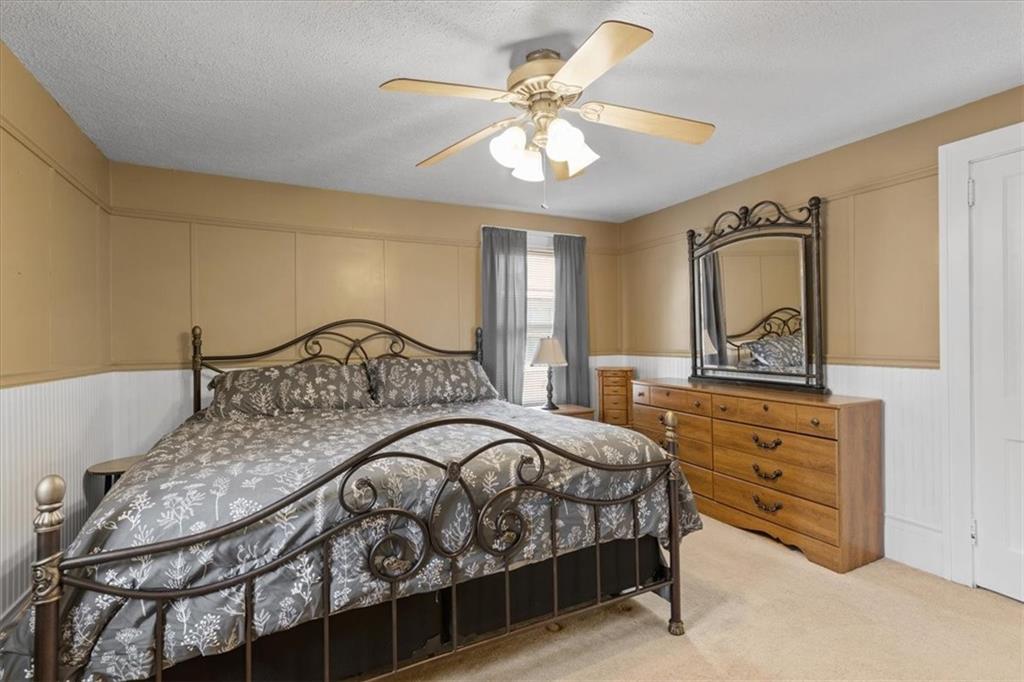 450 Irvin Avenue Rochester, PA 15074 - Photo 18 of 30 a bedroom with a bed a chandelier and dresser