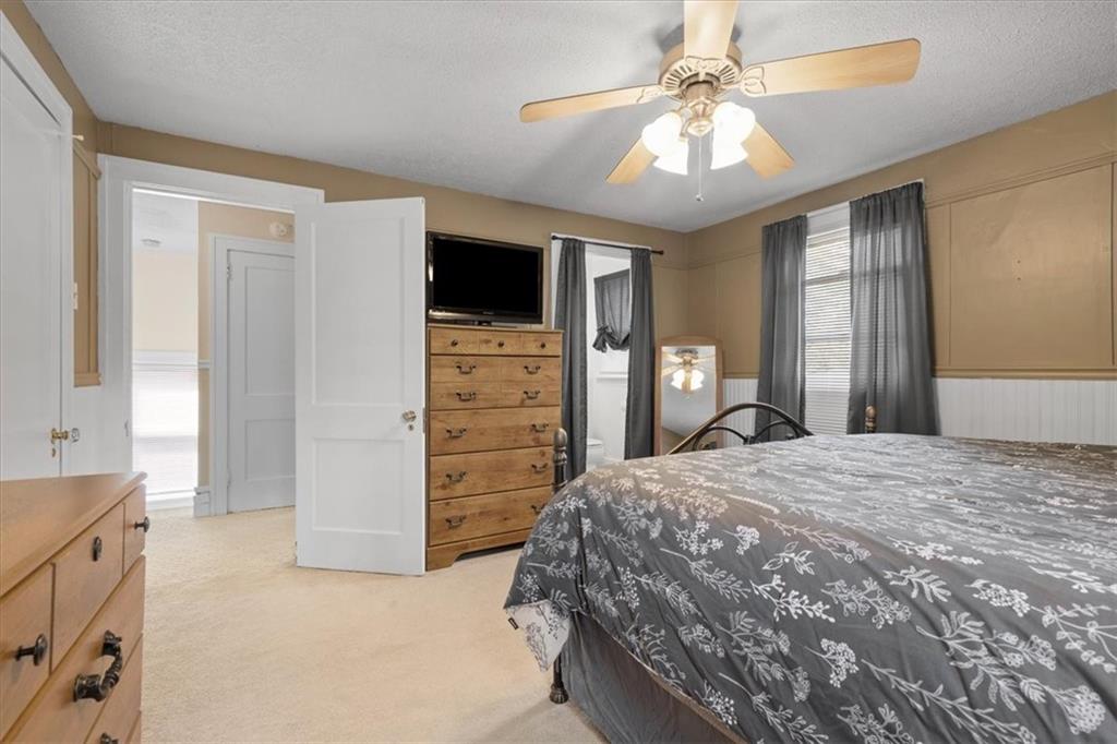 450 Irvin Avenue Rochester, PA 15074 - Photo 20 of 30 a bedroom with a bed and a chandelier