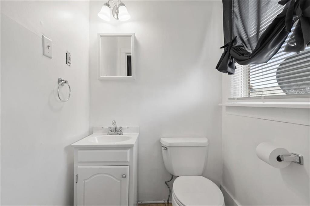 450 Irvin Avenue Rochester, PA 15074 - Photo 21 of 30 a bathroom with a toilet a sink a mirror and vanity
