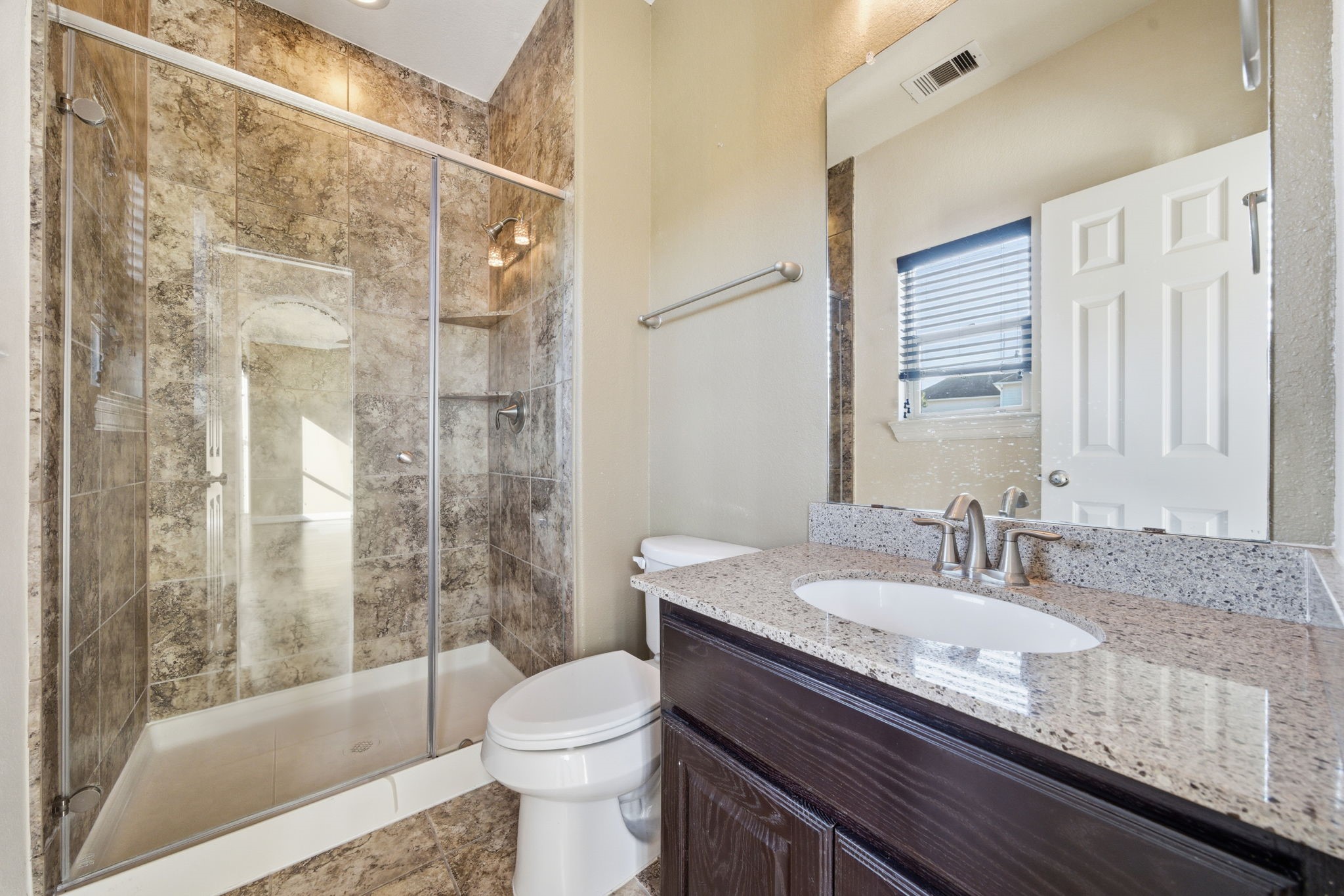 10218 Spring Shadows Park Circle Houston, TX 77080 - Photo 12 of 46 a bathroom with a granite countertop sink toilet and shower