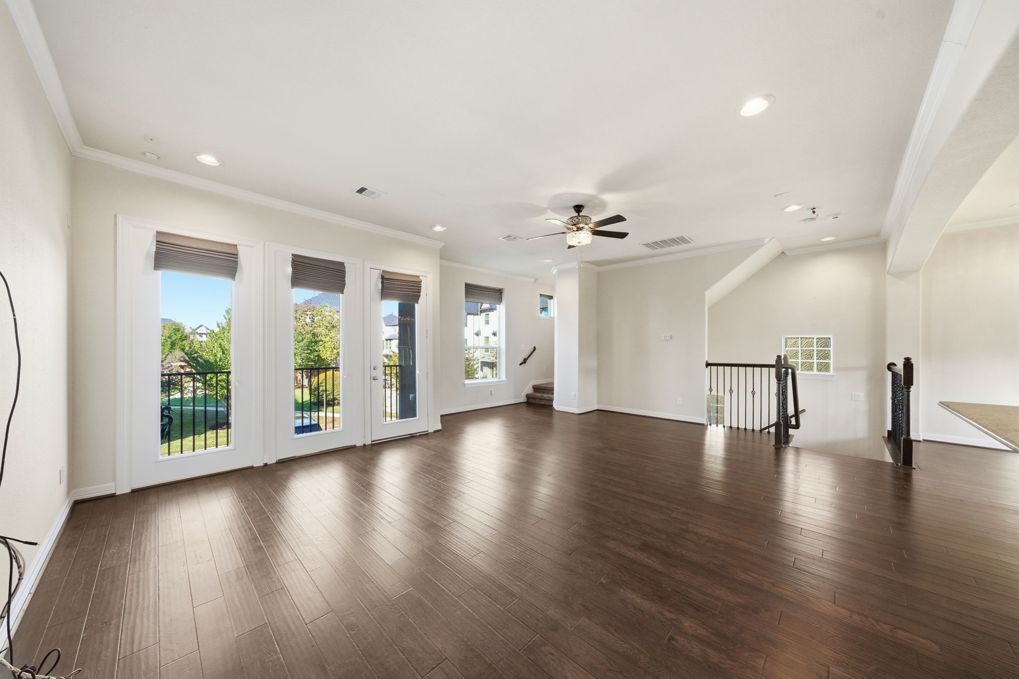 10218 Spring Shadows Park Circle Houston, TX 77080 - Photo 24 of 46 a view of an empty room with wooden floor and a large window