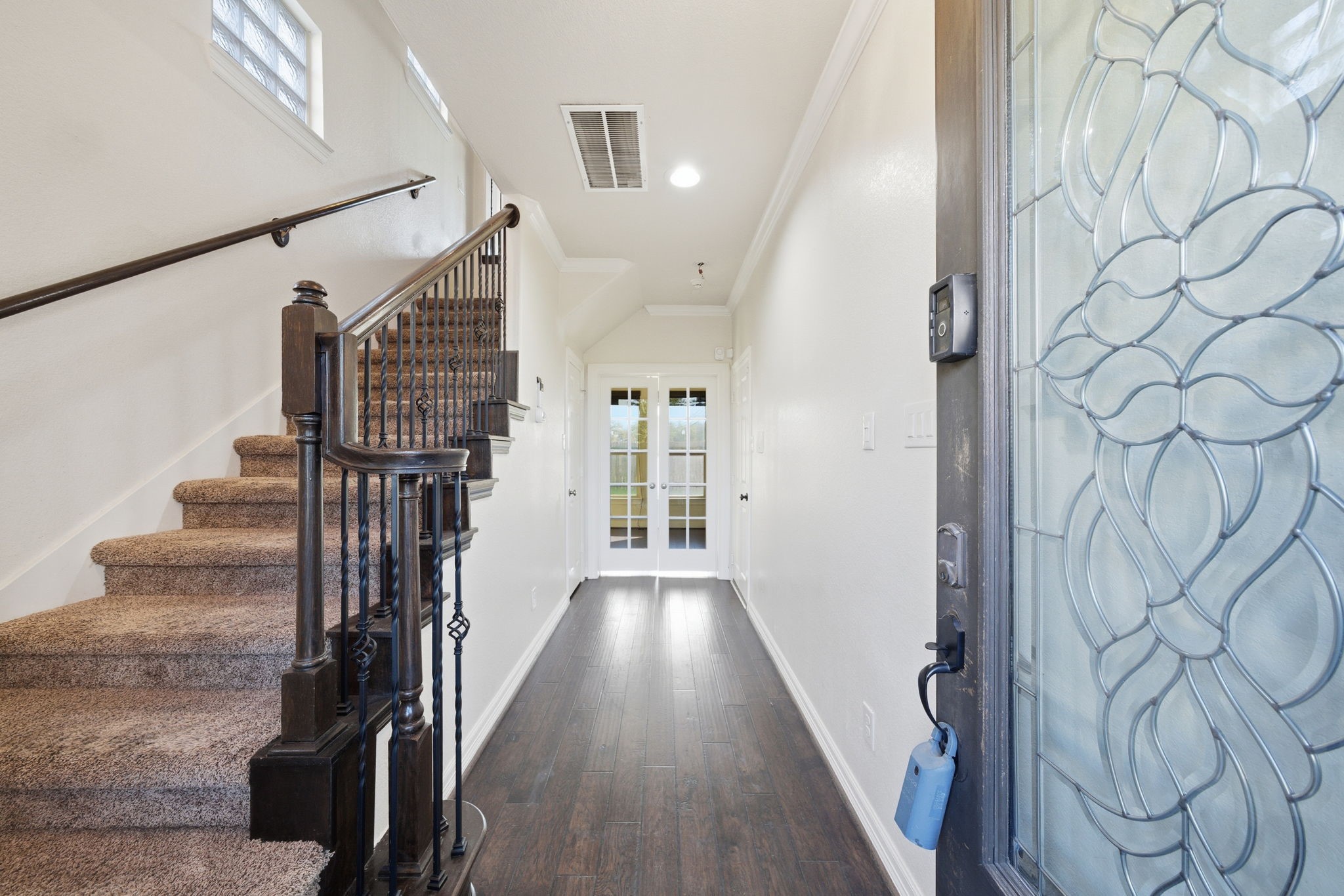 10218 Spring Shadows Park Circle Houston, TX 77080 - Photo 7 of 46 a view of a hallway with wooden floor and entryway