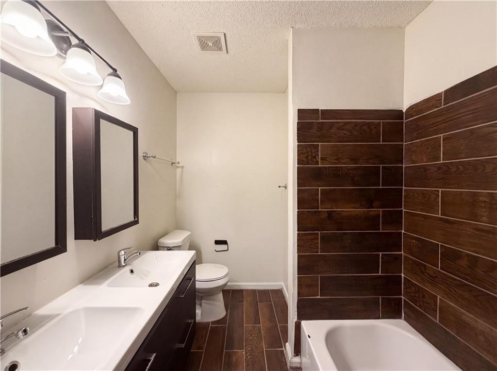 3753 Soapstone Road Decatur, GA 30034 - Photo 12 of 26 a bathroom with a sink a toilet and shower