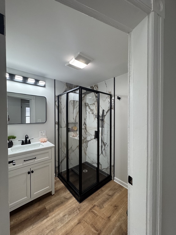 48 Santa Barbara Street Springfield, MA 01104 - Photo 24 of 33 a bathroom with a double vanity sink a mirror and shower