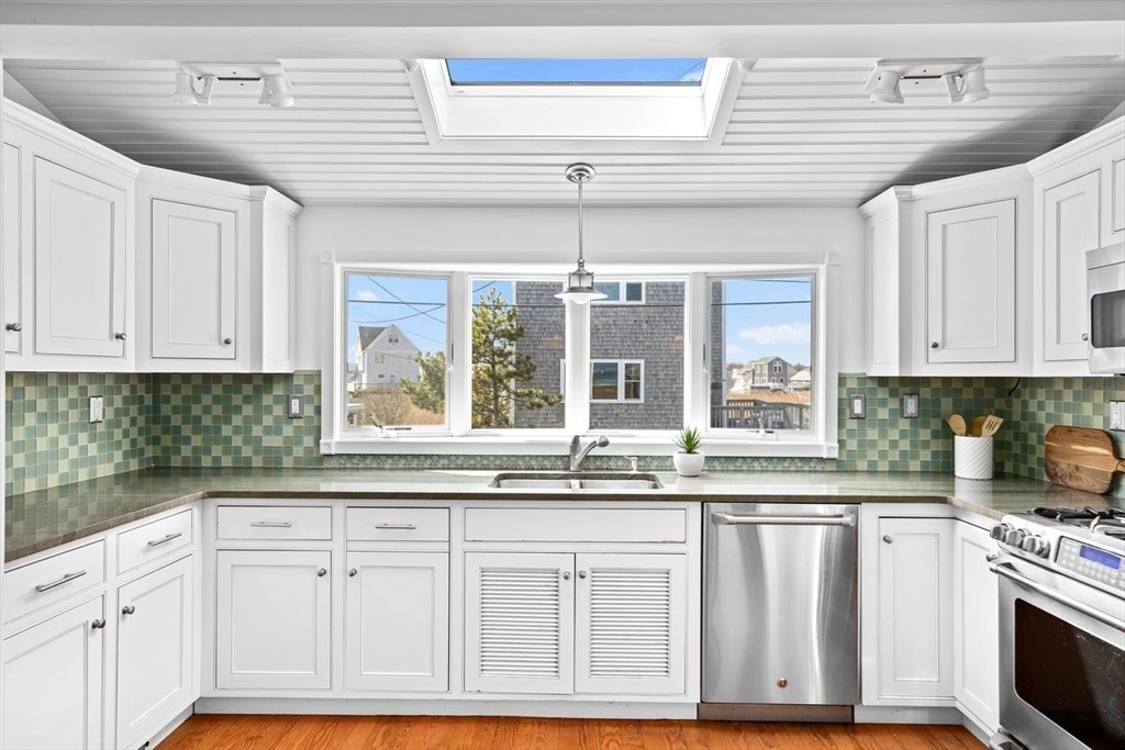 75 Rebecca Road Scituate, MA 02066 - Photo 6 of 42 a kitchen with granite countertop white cabinets and white appliances