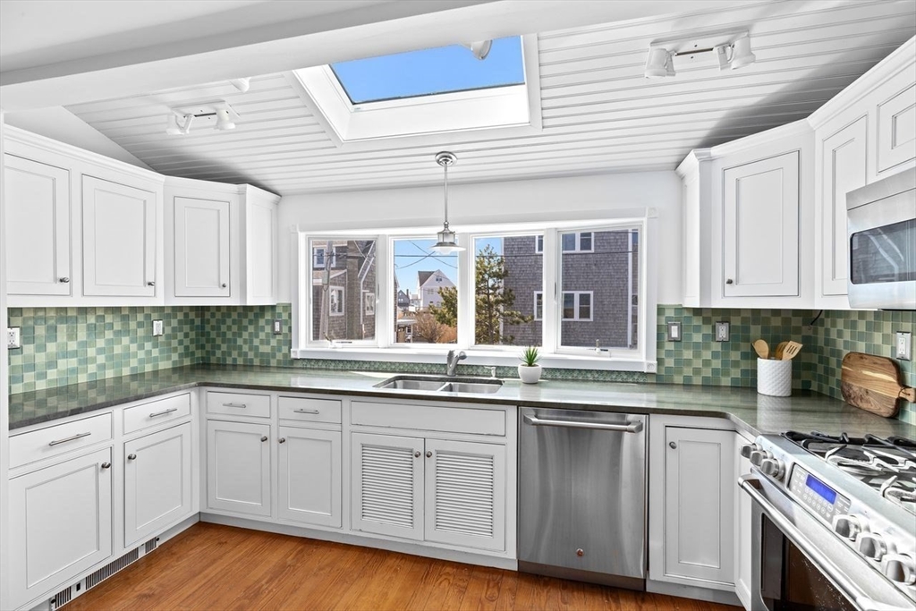 75 Rebecca Road Scituate, MA 02066 - Photo 8 of 42 a kitchen with granite countertop white cabinets and white appliances