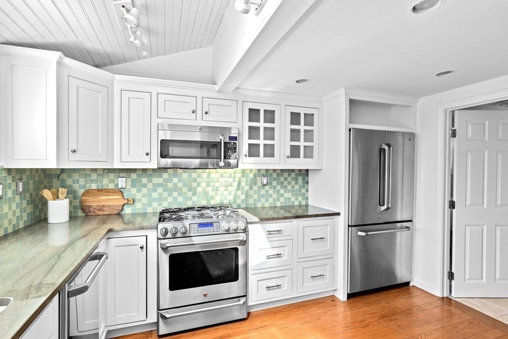 75 Rebecca Road Scituate, MA 02066 - Photo 9 of 42 a kitchen with granite countertop white cabinets and stainless steel appliances