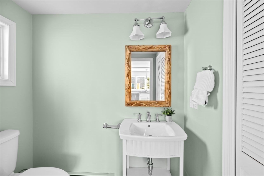 75 Rebecca Road Scituate, MA 02066 - Photo 10 of 42 a bathroom with a sink a toilet and a mirror