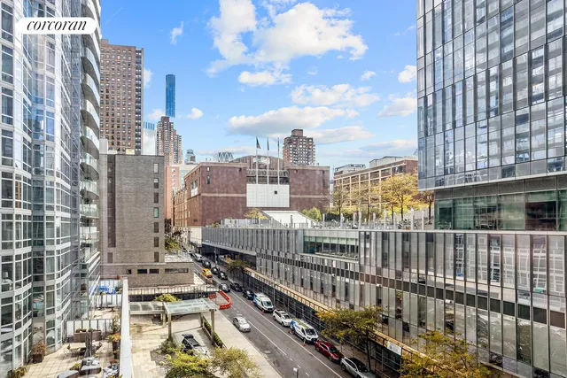 a bedroom with a large bed and a potted plant