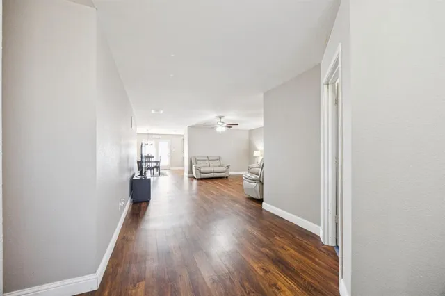 a view of a living room with wooden floor