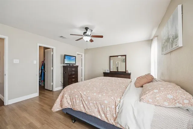 a bedroom with a large bed and a chandelier