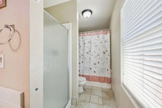 a bathroom with a shower and a toilet