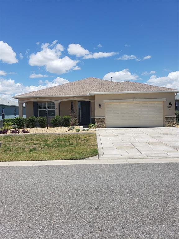 a view of house with a yard