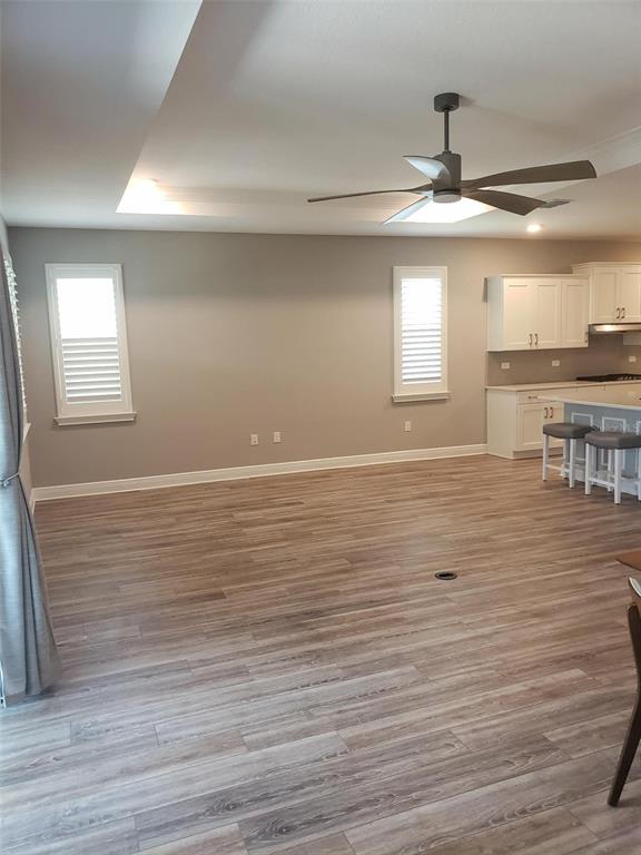 9013 Southwest 79th Lane Ocala, FL 34481 - Photo 11 of 21 a view of kitchen and empty room with wooden floor