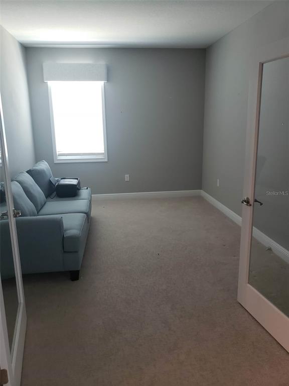 9013 Southwest 79th Lane Ocala, FL 34481 - Photo 12 of 21 a living room with furniture and a window