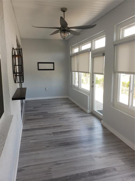 9013 Southwest 79th Lane Ocala, FL 34481 - Photo 19 of 21 an empty room with wooden floor and windows