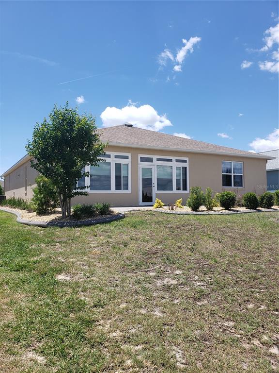 9013 Southwest 79th Lane Ocala, FL 34481 - Photo 20 of 21 a front view of a house with a yard