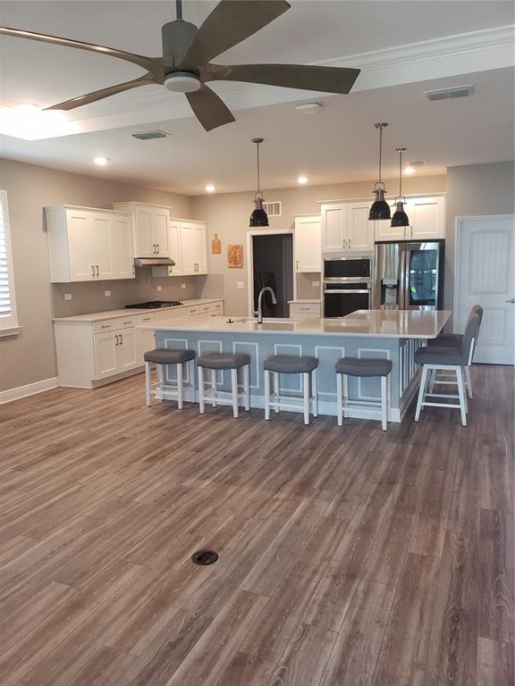 9013 Southwest 79th Lane Ocala, FL 34481 - Photo 4 of 21 a kitchen with stainless steel appliances kitchen island granite countertop a table chairs and a refrigerator