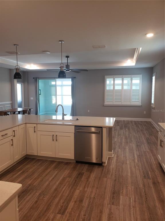 9013 Southwest 79th Lane Ocala, FL 34481 - Photo 7 of 21 a large kitchen with a lot of counter space and wooden floor