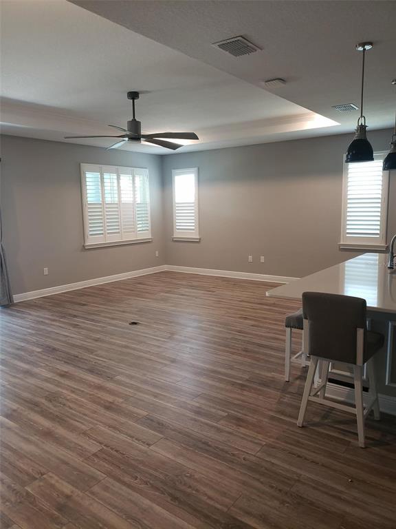 9013 Southwest 79th Lane Ocala, FL 34481 - Photo 9 of 21 a view of an empty room with window and wooden floor