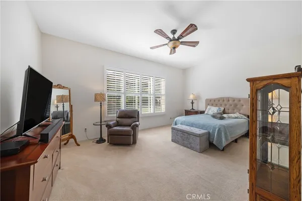 a spacious bedroom with a bed and glass door