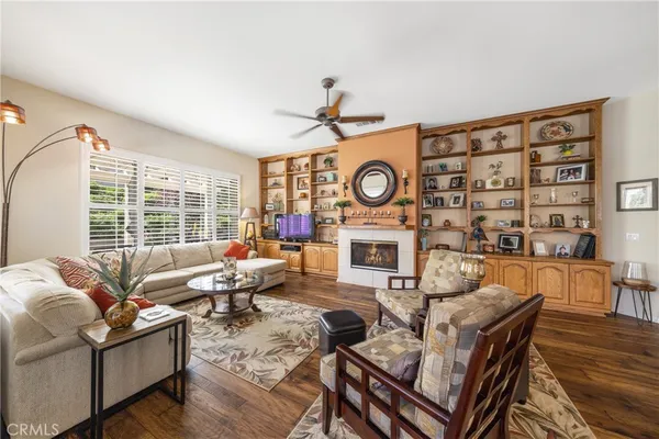 a living room with furniture a fireplace and a large window