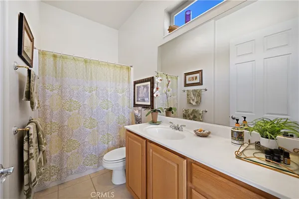 a bathroom with a granite countertop sink a toilet and shower