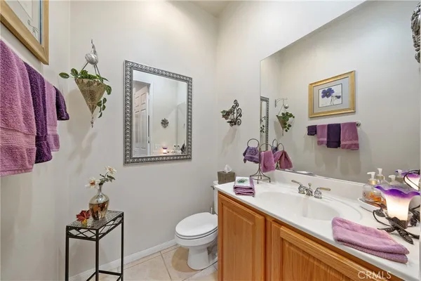 a bathroom with a sink vanity mirror and toilet