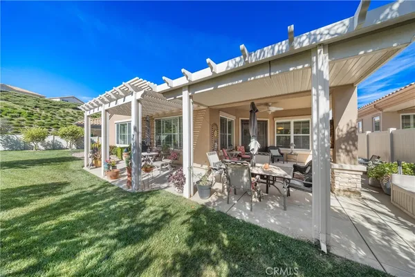 a view of a house with backyard porch and sitting area