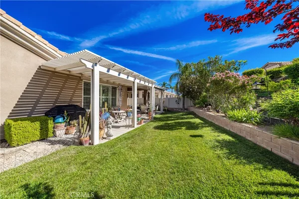 a view of a backyard with plants and a patio