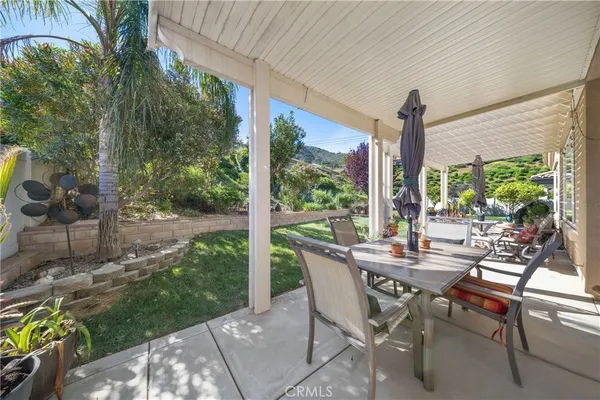 a view of an outdoor dining space with a table and chairs