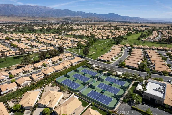 a living room with furniture a chandelier and a large window