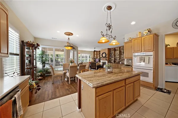 a kitchen with stainless steel appliances granite countertop a sink a stove and a refrigerator