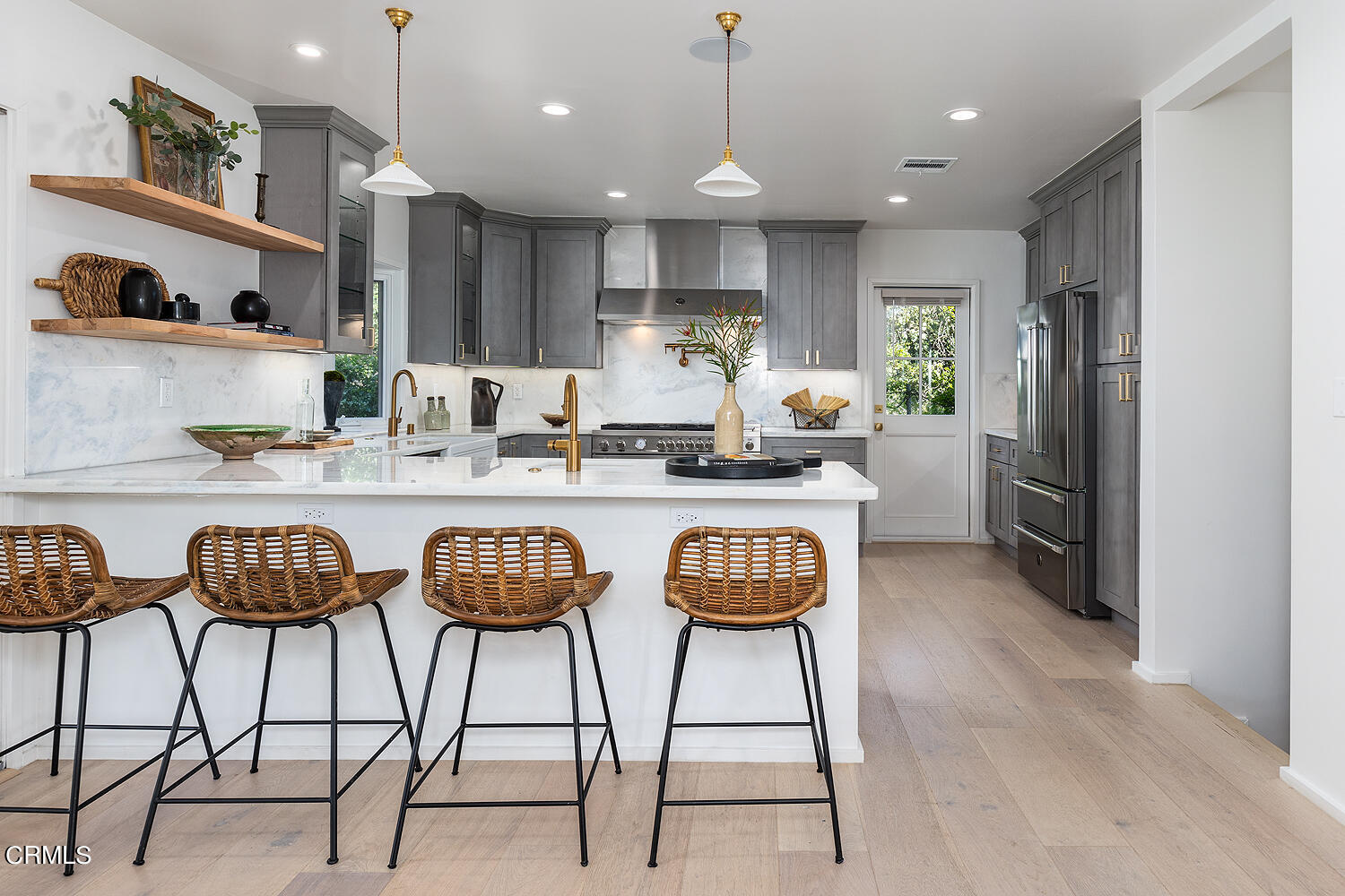 3142 Lincoln Avenue Altadena, CA 91001 - Photo 11 of 48 a kitchen with stainless steel appliances granite countertop a sink a stove a kitchen island with chairs and white cabinets