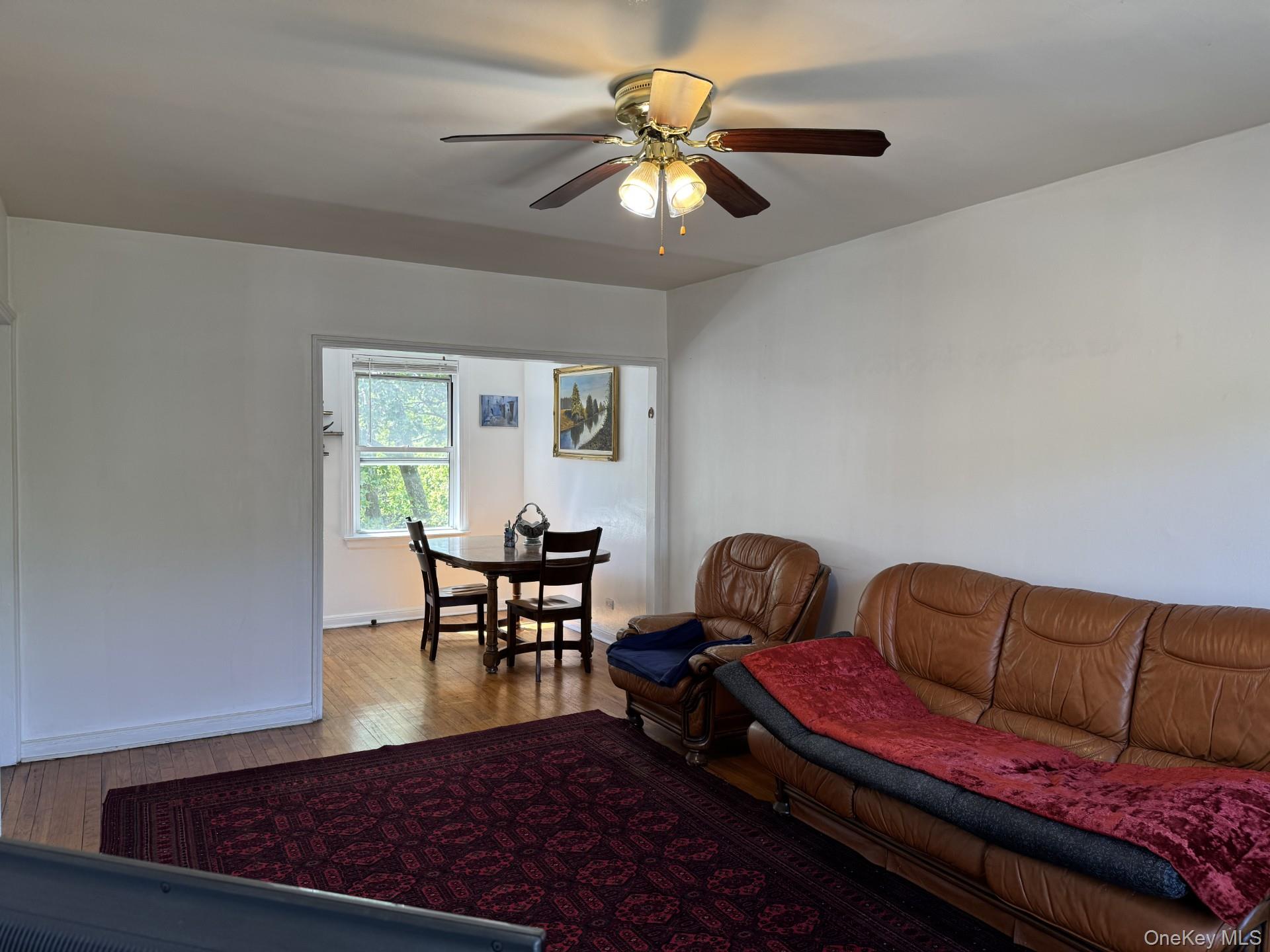 141-24 78th Road, Unit 3A Queens, NY 11367 - Photo 3 of 18 a living room with furniture and a window