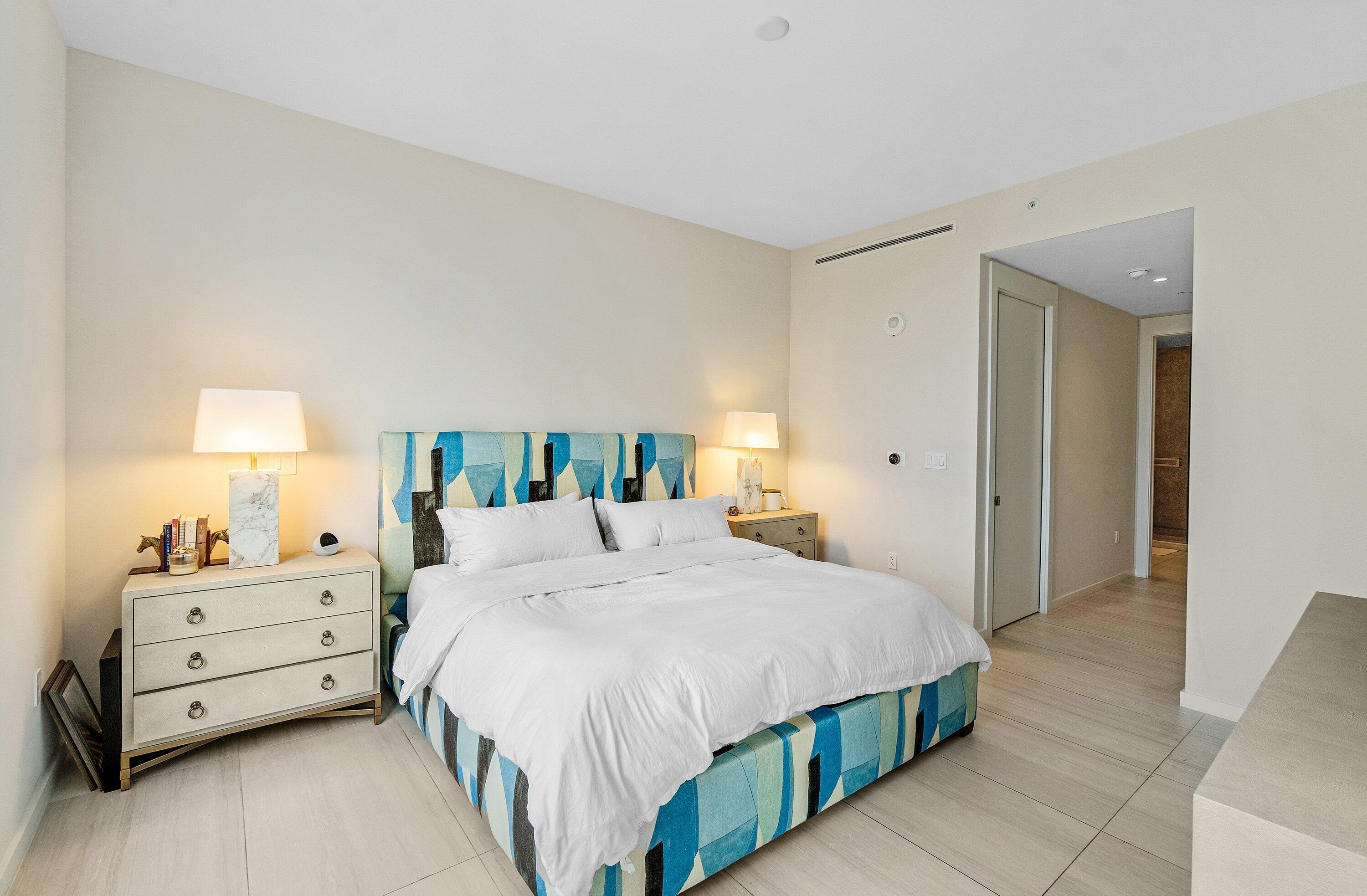 200 Southeast Mizner Boulevard, Unit 810 Boca Raton, FL 33432 - Photo 14 of 29 a bedroom with a bed and a lamp