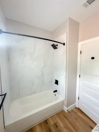 a bathroom with a bathtub and a shower