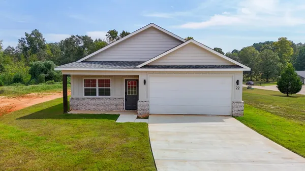 a front view of house with yard and garage