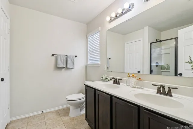 a bathroom with a sink a toilet and a mirror