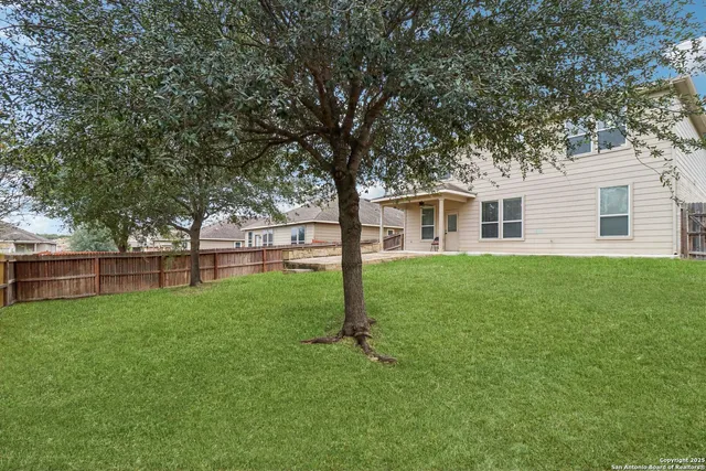 a view of a house with yard and tree s