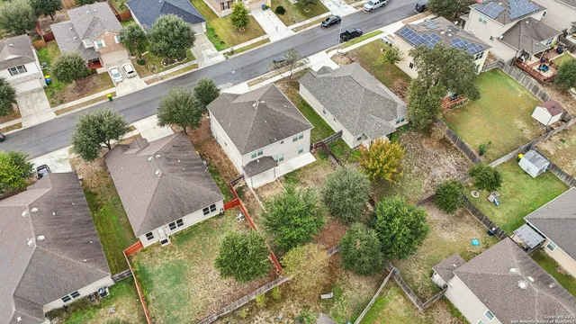 an aerial view of a house with a yard and a garage