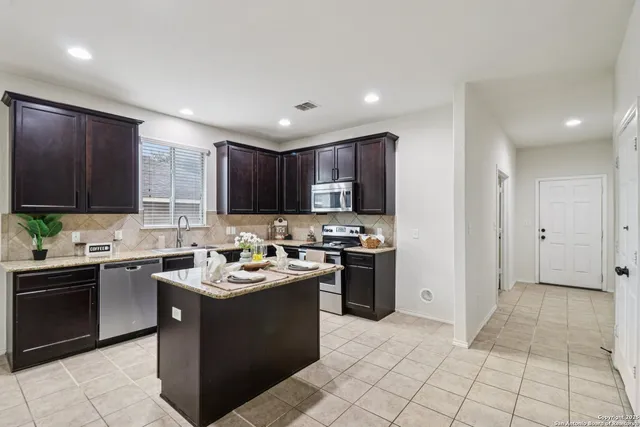 a kitchen with a sink a stove and cabinets