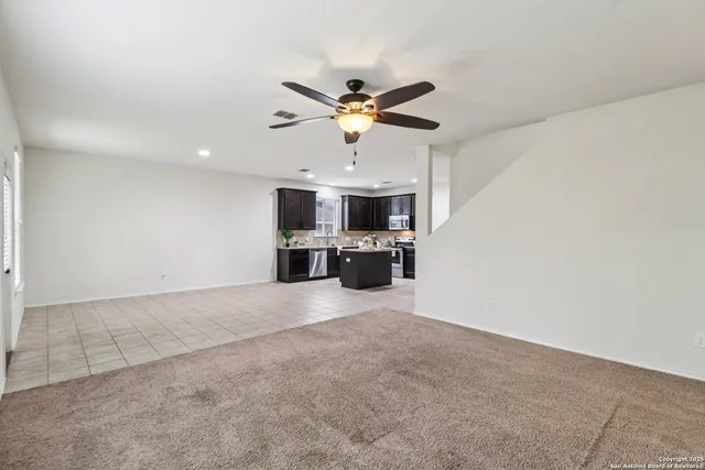 an empty room with a empty space and a ceiling fan