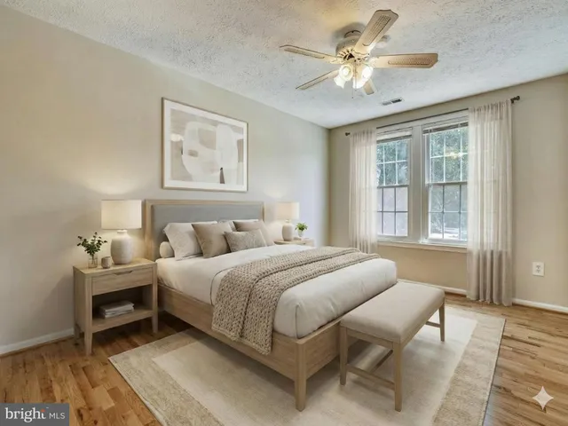 a spacious bedroom with a bed and a chandelier